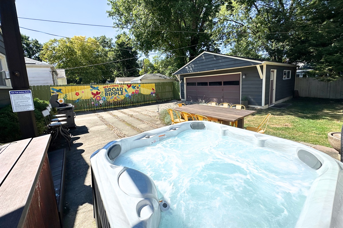 Fully fenced backyard retreat with hot tub, grill, seating & grass for the pup!