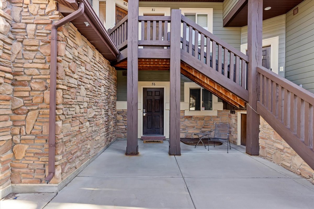 A private exterior entryway framed by rustic stonework, providing both convenience and a warm first impression.