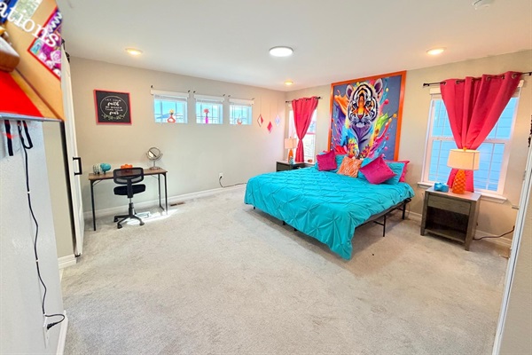 Enjoy the primary king bedroom with 55" TV, small desk and chair.