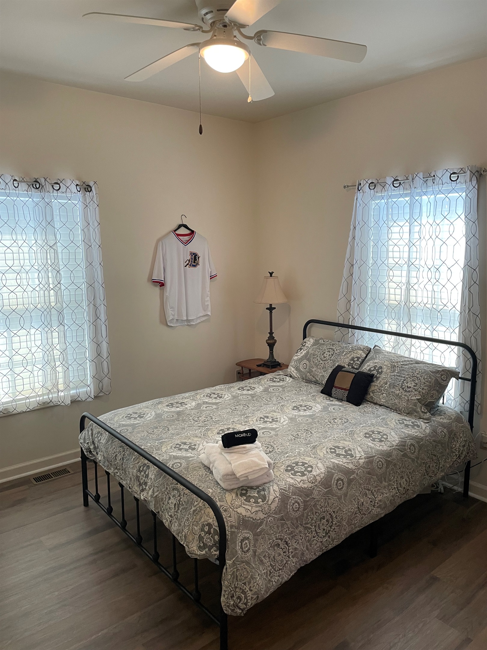 Durham Bulls throwback jerseys and vintage baseball gear complete the Bull Pen theme in the queen bedroom