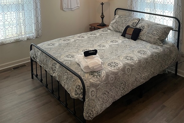 Durham Bulls throwback jerseys and vintage baseball gear complete the Bull Pen theme in the queen bedroom