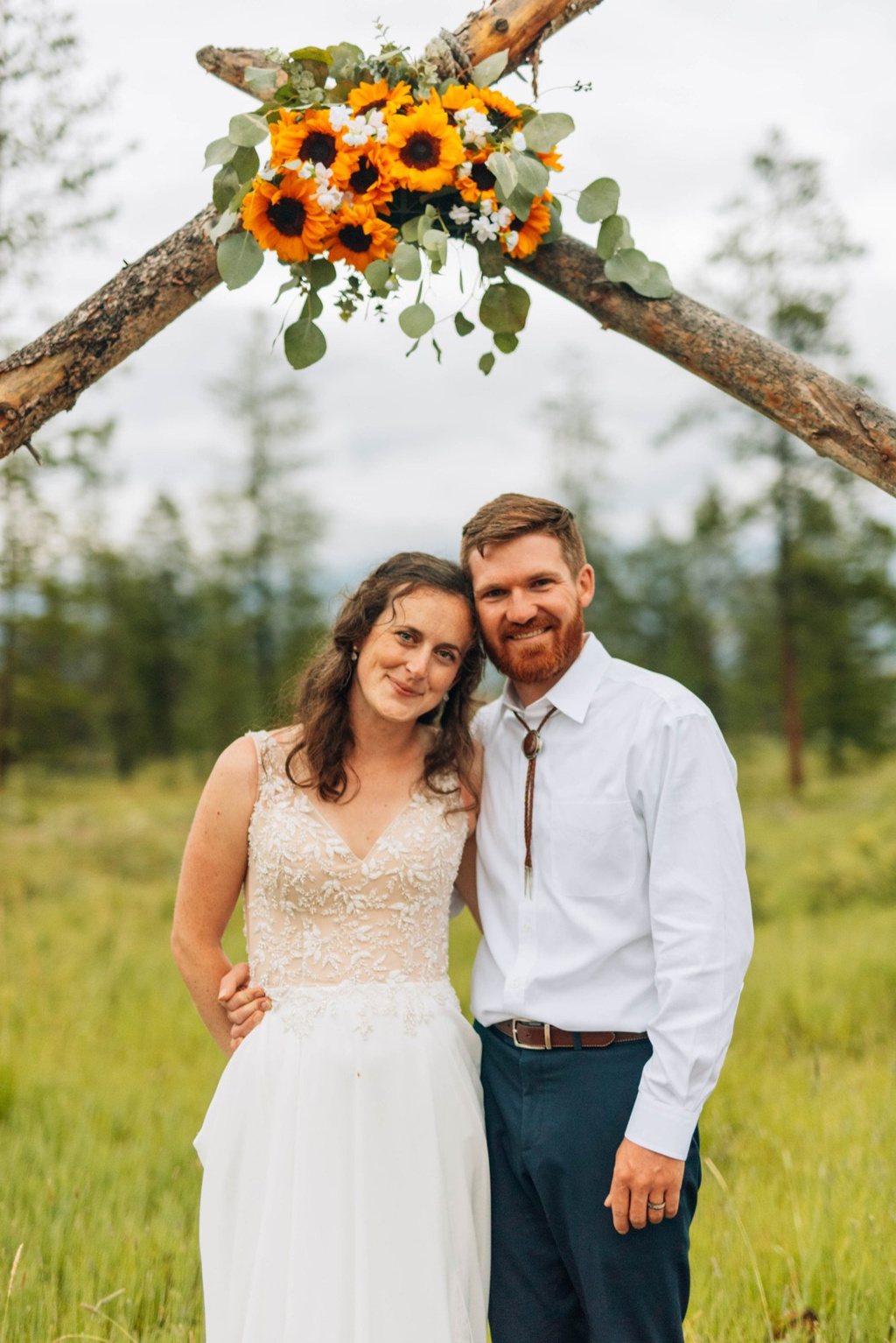 Couple under the ceremony arch