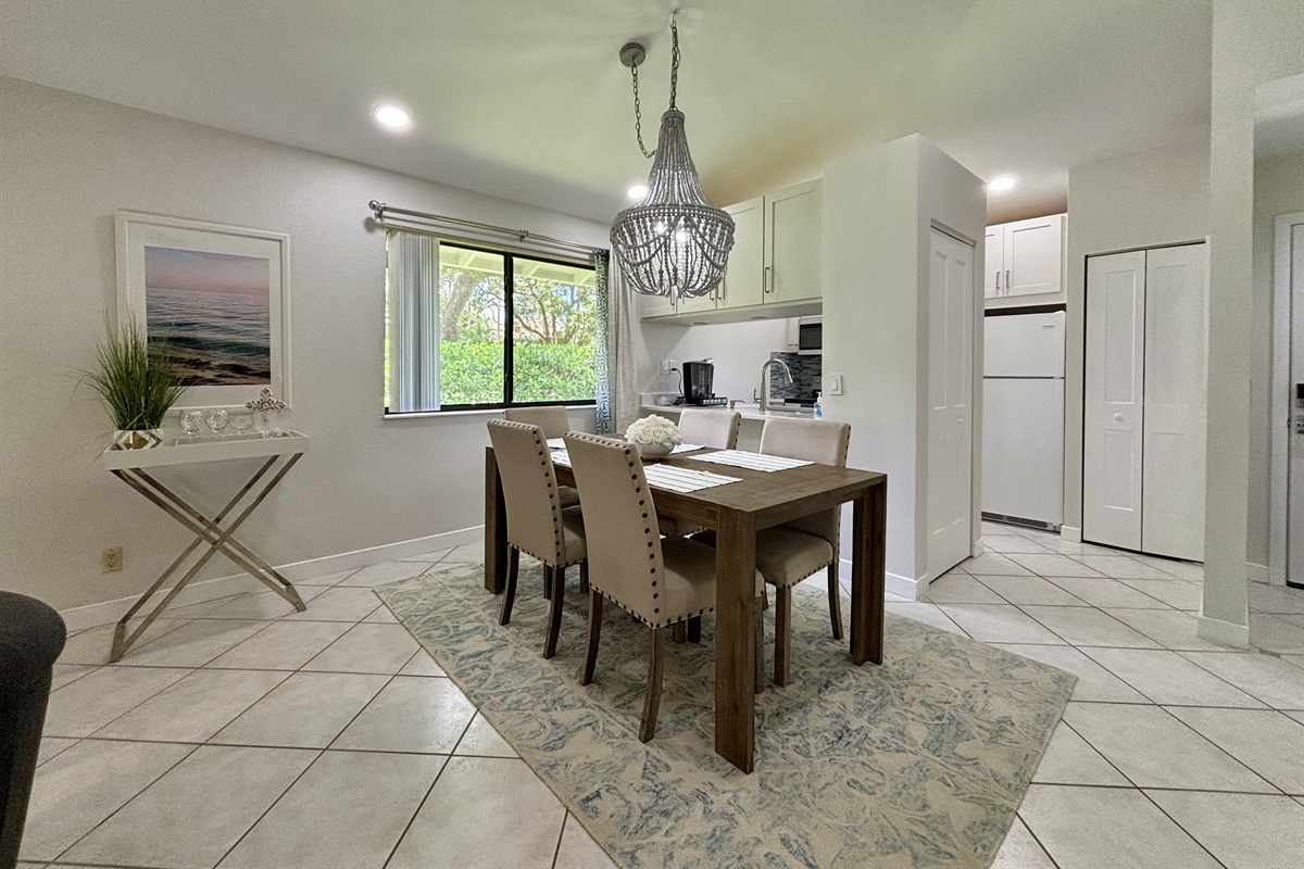 The dining area is right off the kitchen with seating for five, with a convenient bar area located by the window.