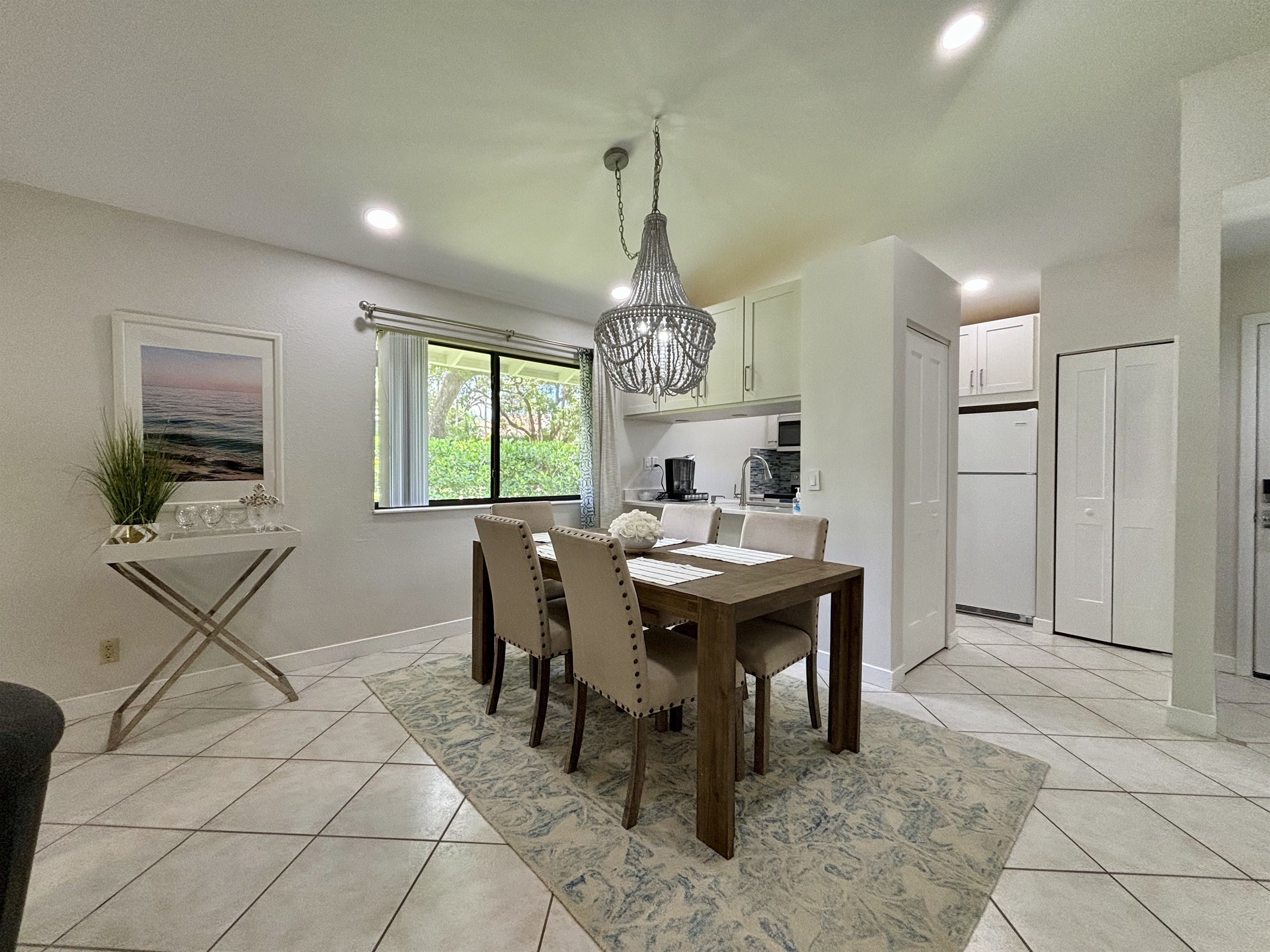 The dining area is right off the kitchen with seating for five, with a convenient bar area located by the window.