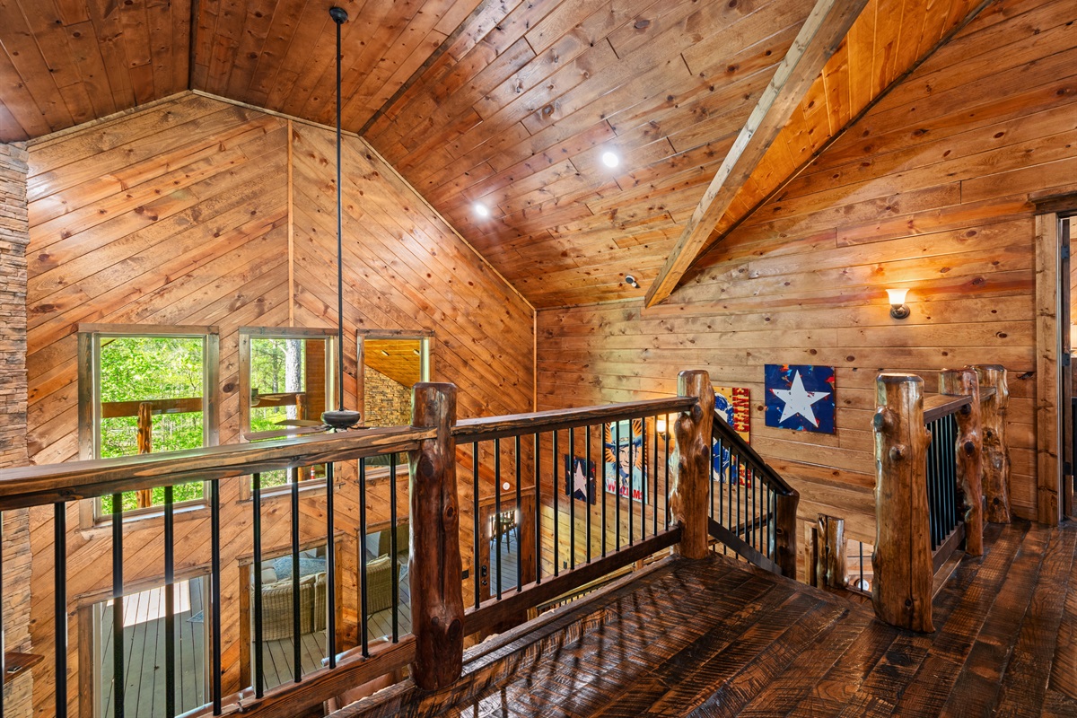 The open loft overlooks the main living area below, adding to the airy feel of the home while still providing its own private space to relax.