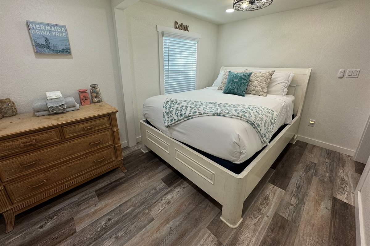 Bedroom with queen bed and smart tv