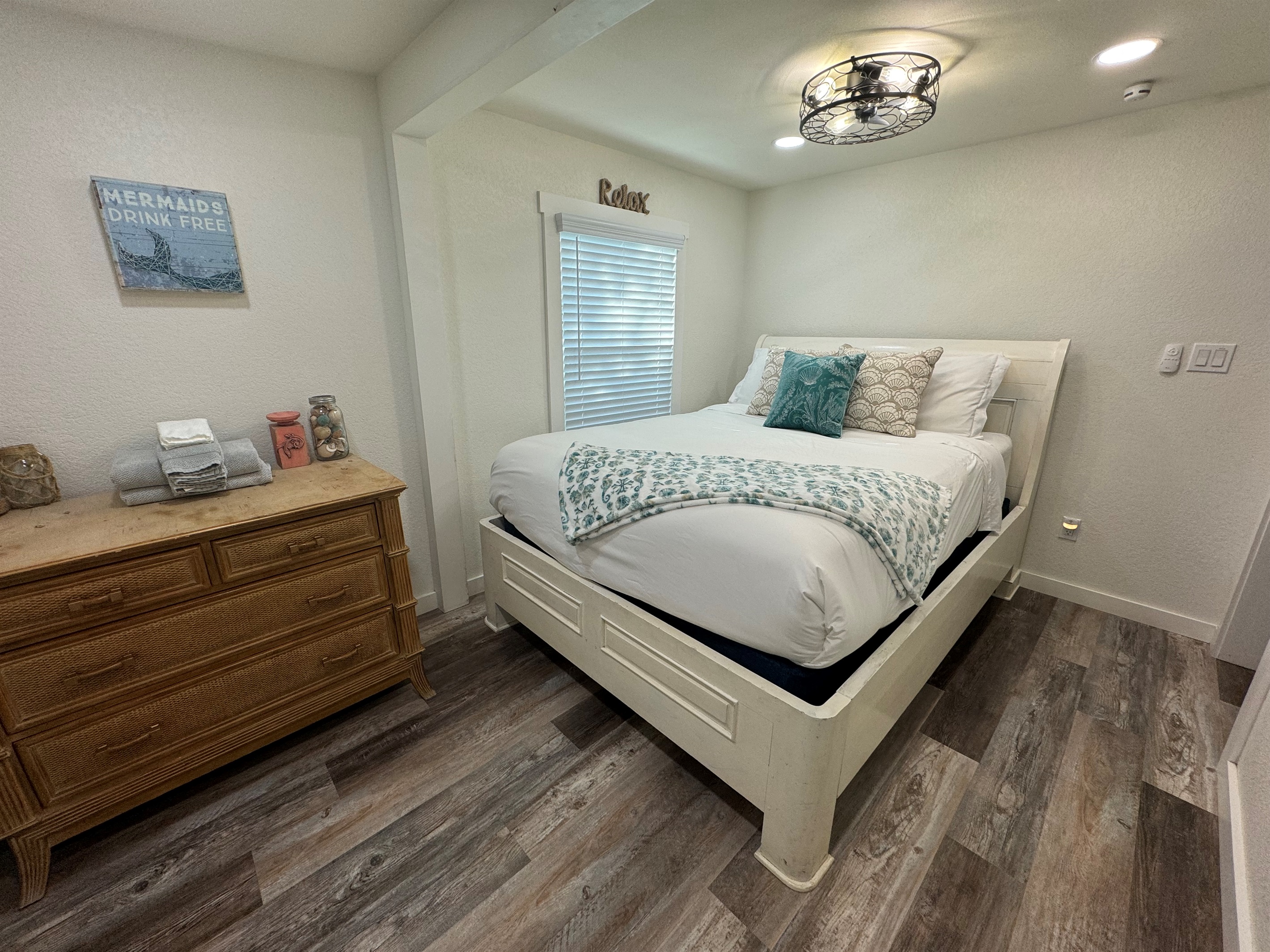 Bedroom with queen bed and smart tv