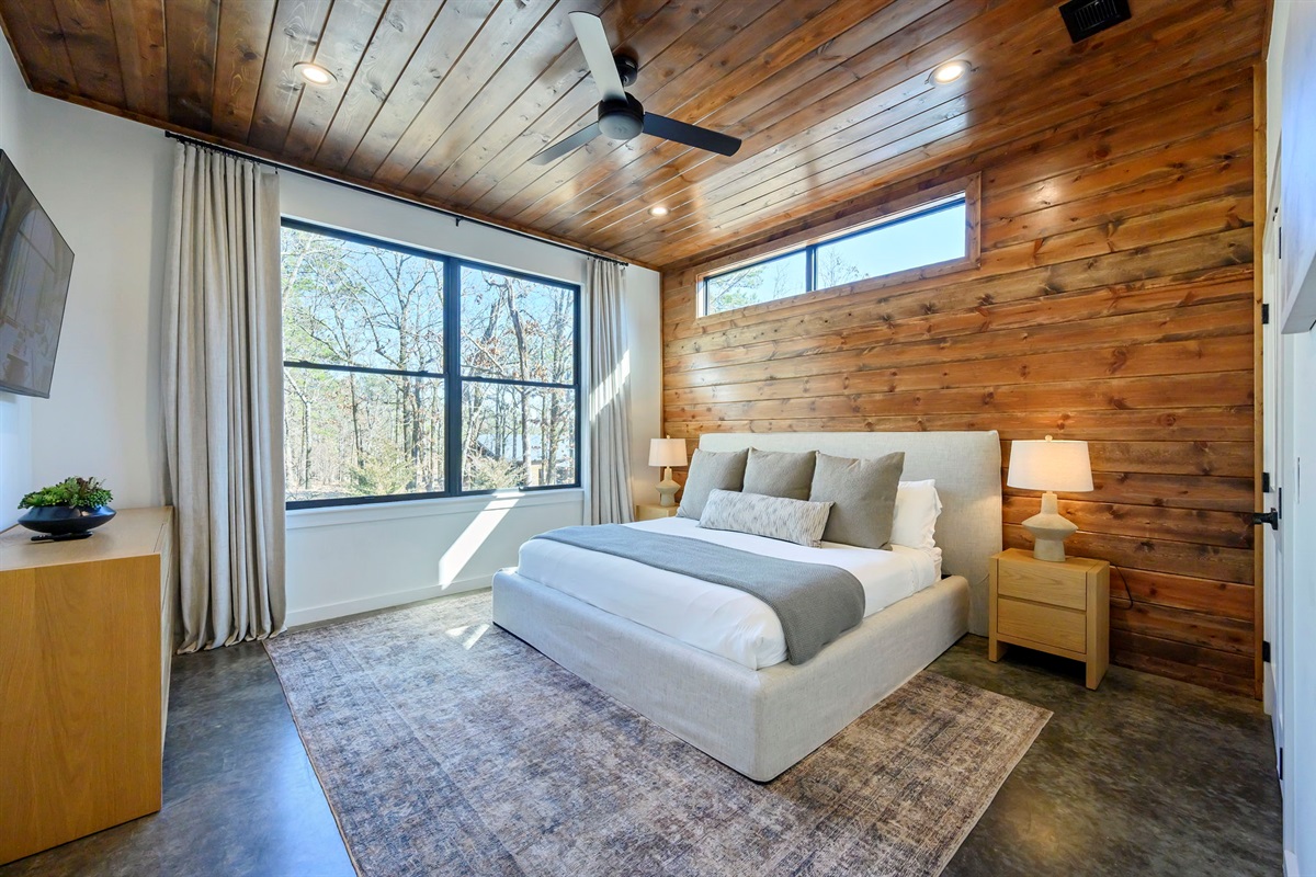 King Suite 3 - Large and spacious suite with cedar wood paneling, designer finishes, smart TV, premium king mattress, and luxury bedding. Includes stunning views of the hardwood forest. 