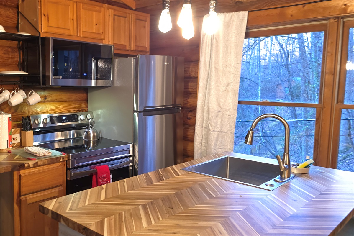 This fully equipped kitchen blends rustic warmth with modern convenience, making mealtime a true cabin delight.