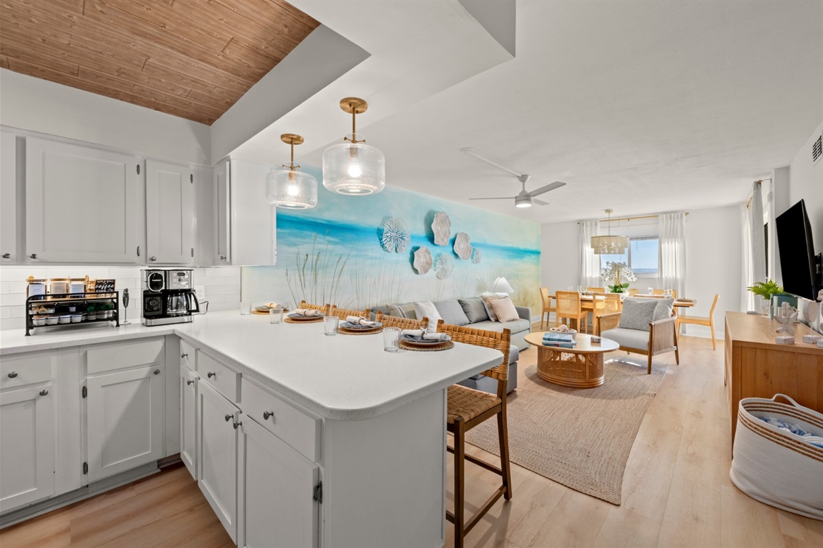 Gather at the oversized island for coffee and breakfast, then flow into the airy living and dining space for comfort and coastal relaxation.