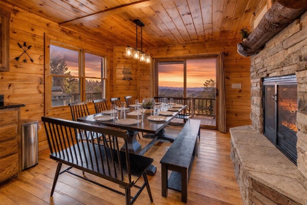 Dining area right off the fully-stocked kitchen that has seating for 12, with double-sided fireplace between dining area and living room.
