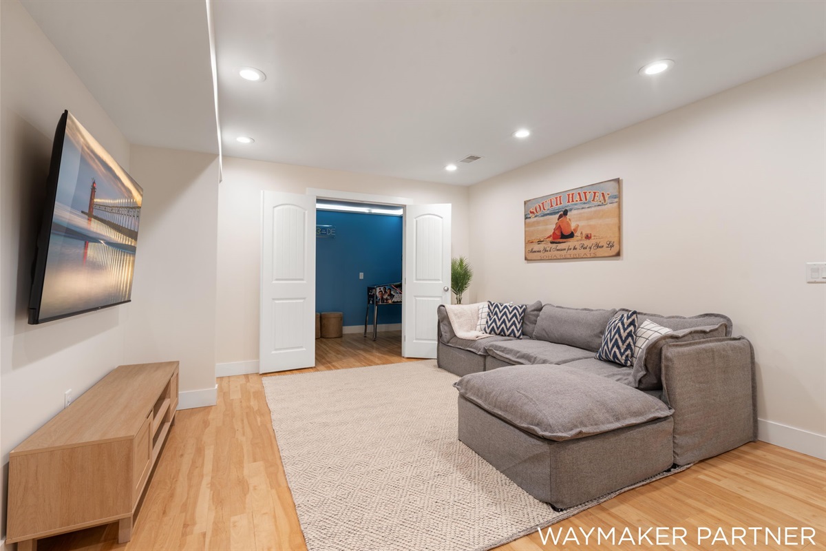 Walk downstairs to our relaxing fun living room #3 leading to the arcade room