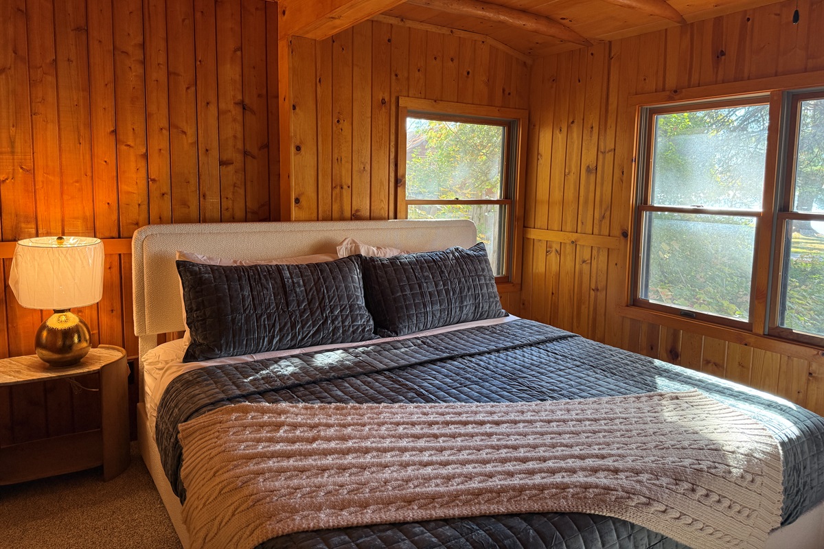 The primary bedroom on the main floor has a king-size bed with a Zinus memory foam mattress. A Jack-and-Jill bathroom is shared by the two main floor bedrooms.