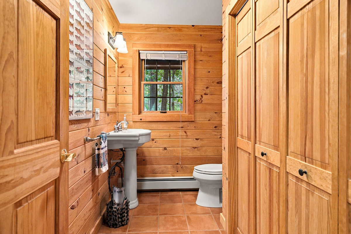 Convenient half bathroom located near the main living area.  The laundry area is in the closet on the right.