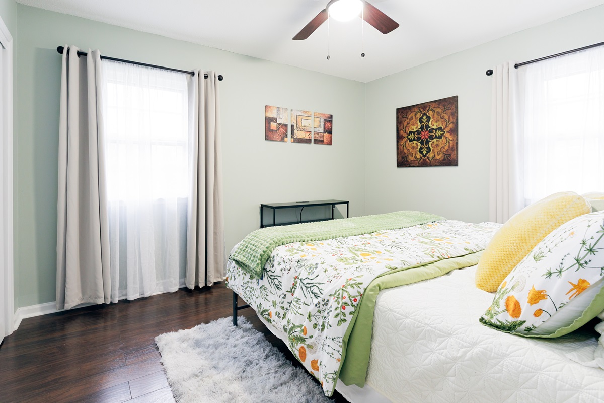 Spacious primary bedroom with king bed, ceiling fan, and a calm, comfortable atmosphere. 50" TV added and shown in next picture.