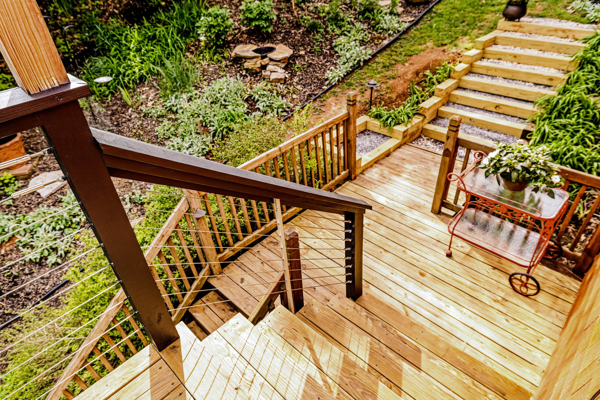 From the main floor deck descend down to the left to reach the lower deck. Or wander up the hill to see the blend of naturalized plants and perennials.