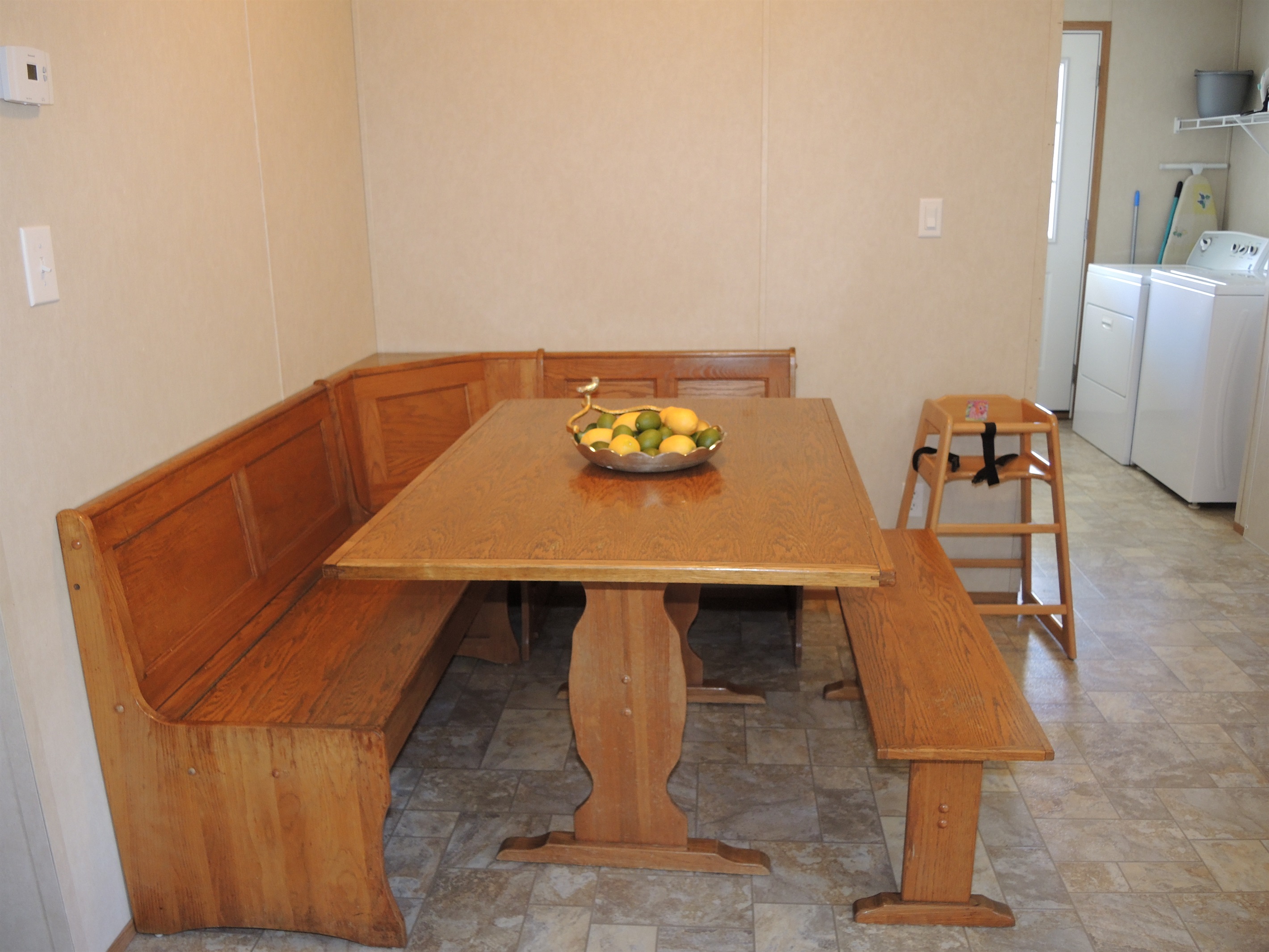 Dining nook with laundry beyond