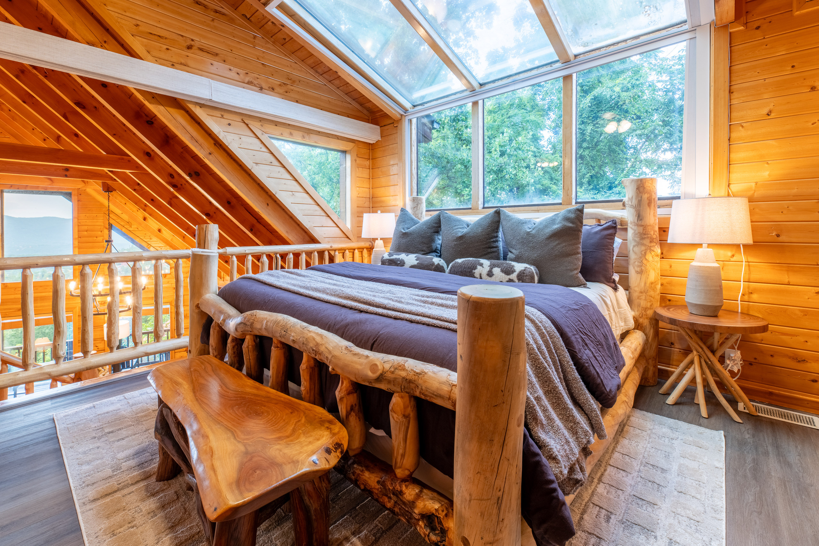 Master bedroom with king bed in the loft with motorized blinds give guests another space to enjoy the mountain views or gaze into the stars through the skylight windows.

Remote controlled blinds can be closed for added privacy.