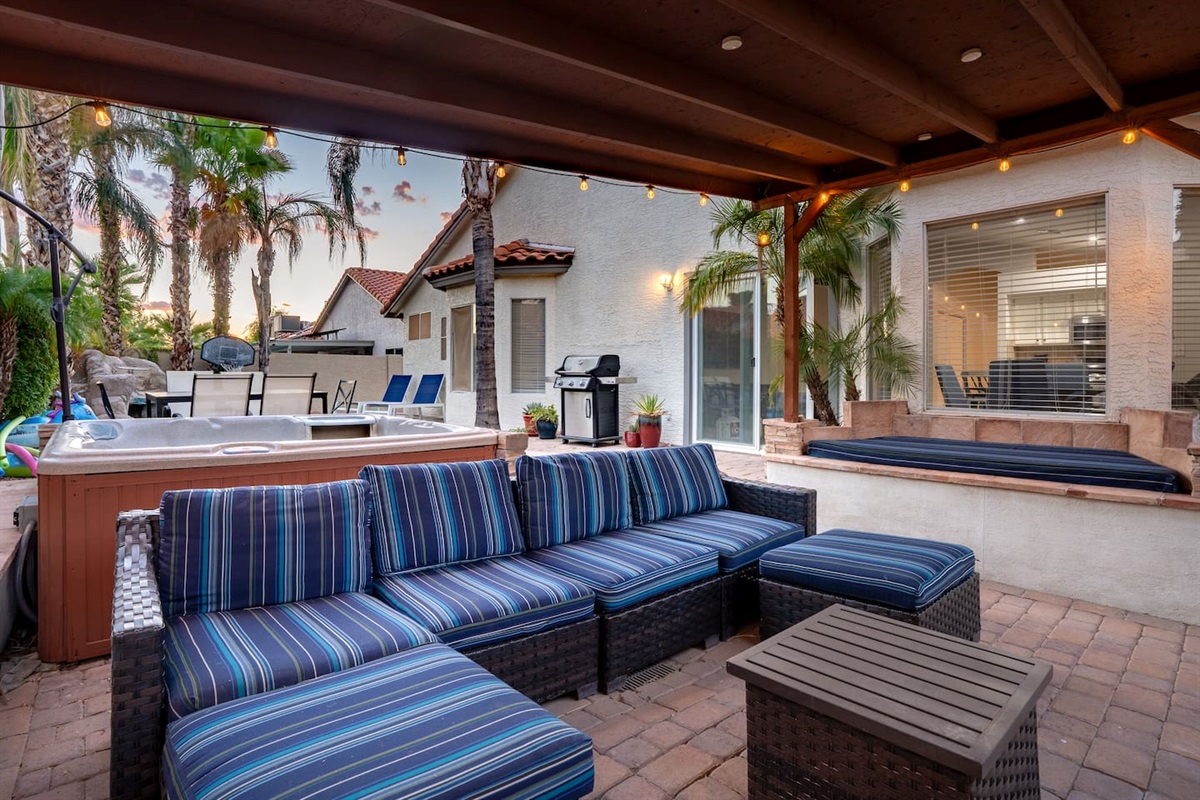 The patio is an outdoor paradise, with a relaxing hot tub, TV and plenty of seating.