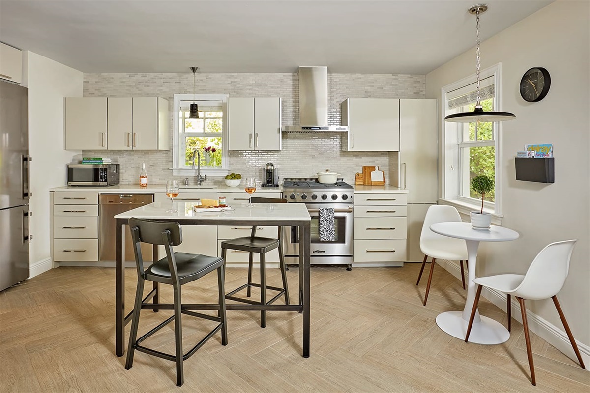 Cottage - Additional professional chef’s kitchen, complete with a Thor gas range, quartz counters, an island that seats four and a charming café table for two, which can easily double as a work station for those working from home.