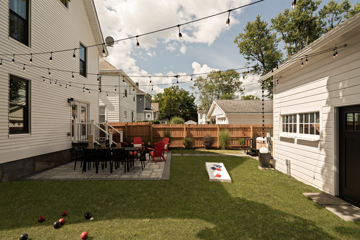 The backyard really comes to life in the evening. Gather around the dining table, break out the yard games, and enjoy the warm glow overhead—a space made for lingering outside together long after the sun goes down.