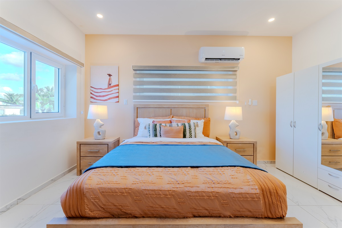 A stylish Queen suite with ample wardrobe storage and modern decor