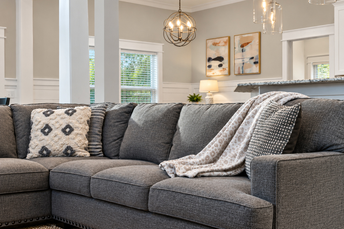 Relax and unwind in this spacious living room, featuring comfortable seating, coastal inspired décor, and plenty of room for the whole family.