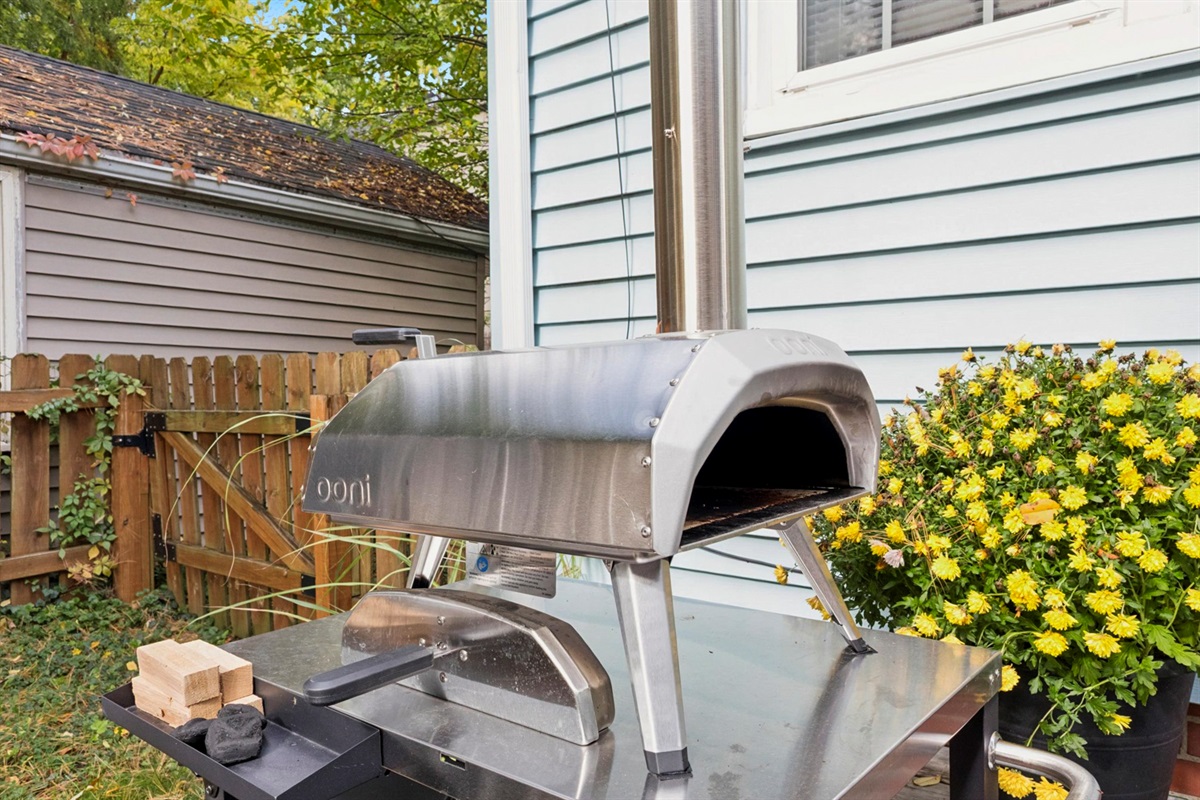Fire up flavor in our South Bend backyard—pizza oven station with peels, turning tools, and provided wood and charcoal makes alfresco cooking easy. Perfect for cozy nights near Notre Dame.