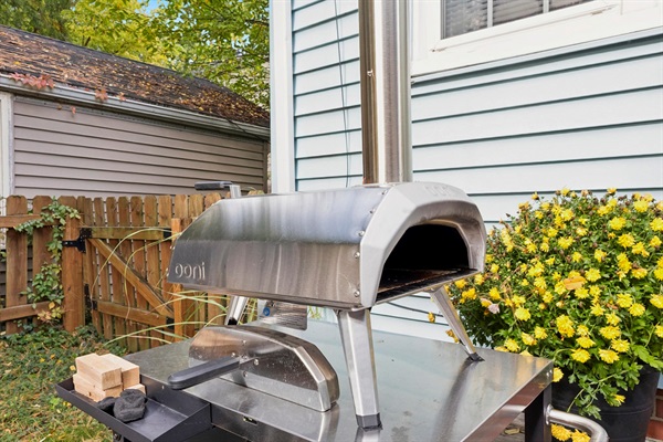 Fire up flavor in our South Bend backyard—pizza oven station with peels, turning tools, and provided wood and charcoal makes alfresco cooking easy. Perfect for cozy nights near Notre Dame.