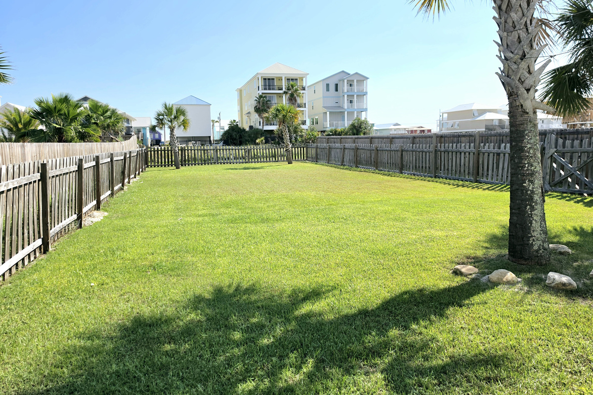 Fenced backyard with open lawn