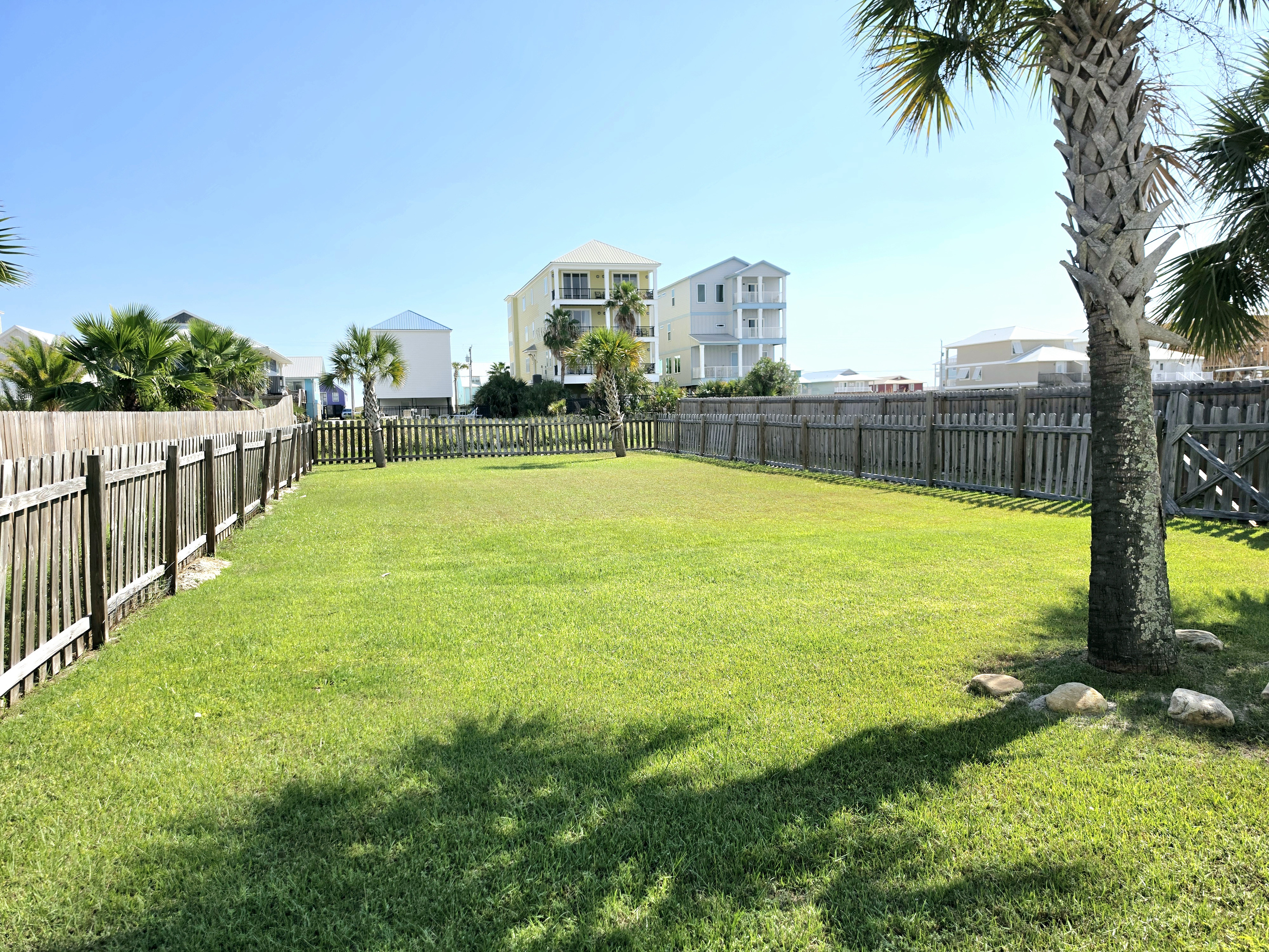 Fenced backyard with open lawn