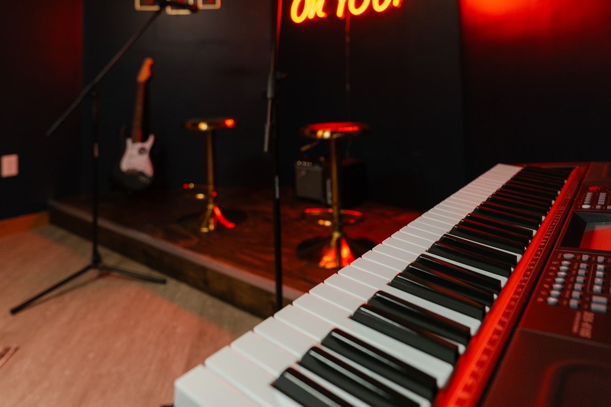Don’t miss out on late-night jam sessions in this music room, complete with a keyboard, guitars, microphones, and performance setup.