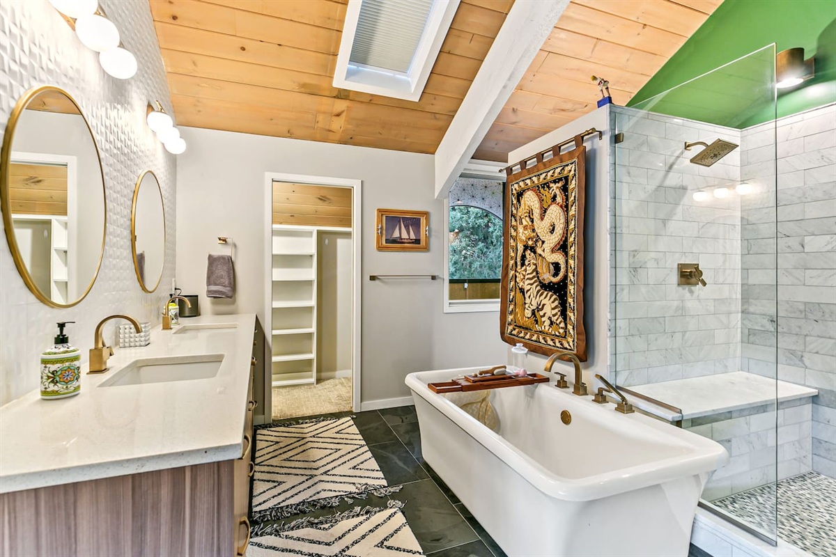 The master bedroom is equipped with a luxurious king bed, a private bath, a bidet toilet, a dual shower system, a deep bathtub, a twin sink setup, and a private closet for your convenience.