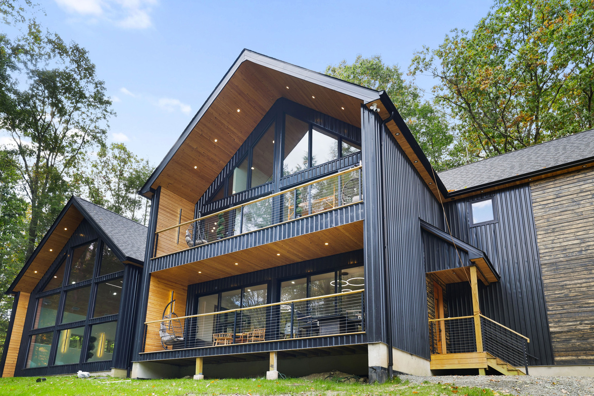 Arrive at your modern Scandinavian villa, all dark metal, warm wood and glass balconies
