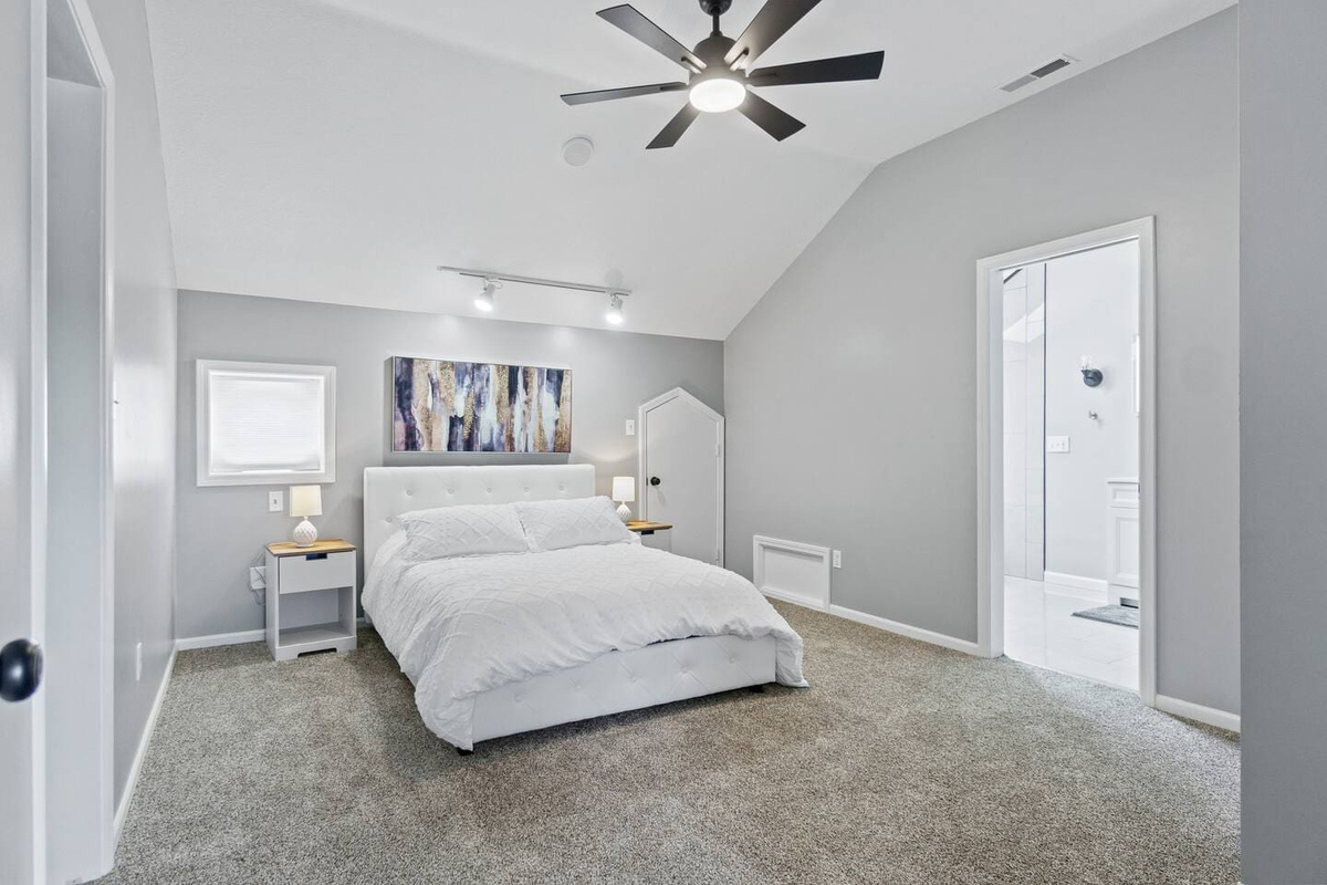 Cozy and spacious bedroom featuring a comfortable queen-sized bed, designed for relaxation and a restful night's sleep.