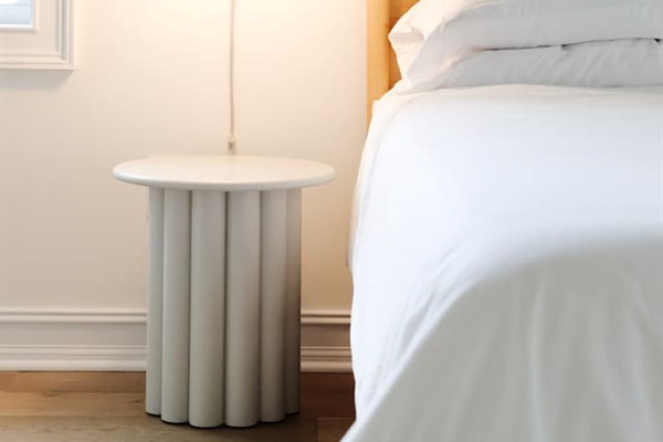 The spacious primary bedroom is a serene place to relax and recharge. The primary features a king sized bed, accents from CB2, walk-in closet, 50" Smart TV, and a full bath with a soaking tub and standup shower. 