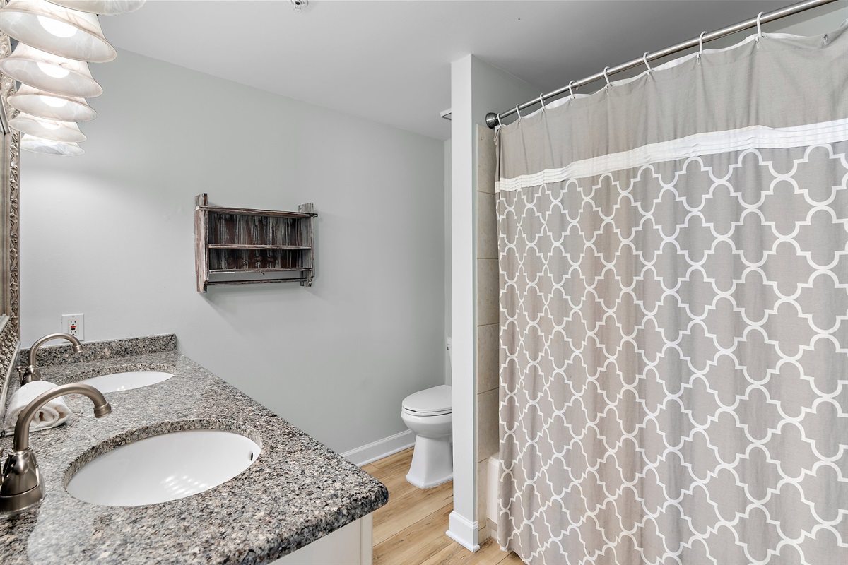 Spacious master bedroom features a King bed, Gulf views, balcony access, SMART TV w/ cable access, bathroom with dual vanity and shower/tub combo, and large closet.