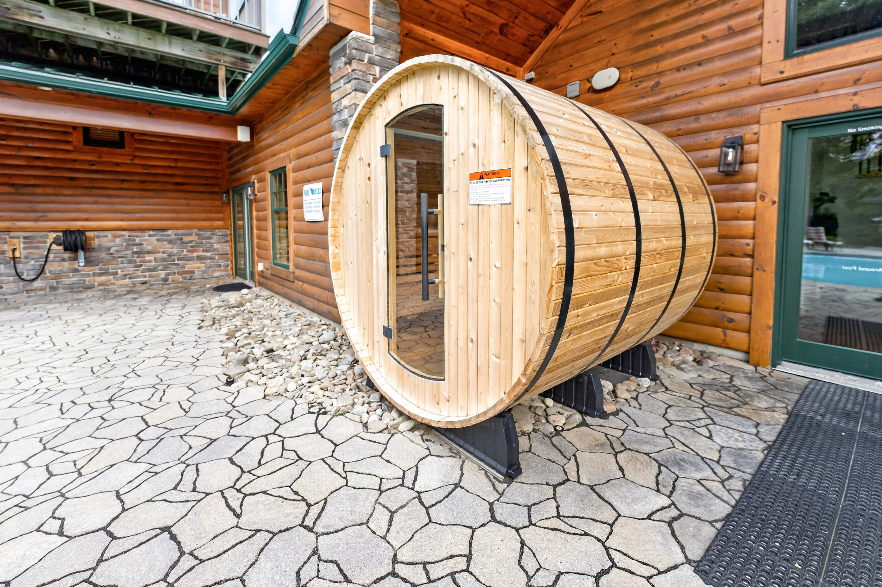 Barrel sauna on the stone patio