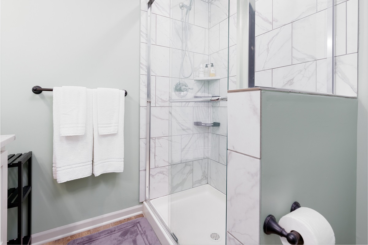 Private ensuite bathroom featuring a walk-in shower and clean, contemporary finishes.