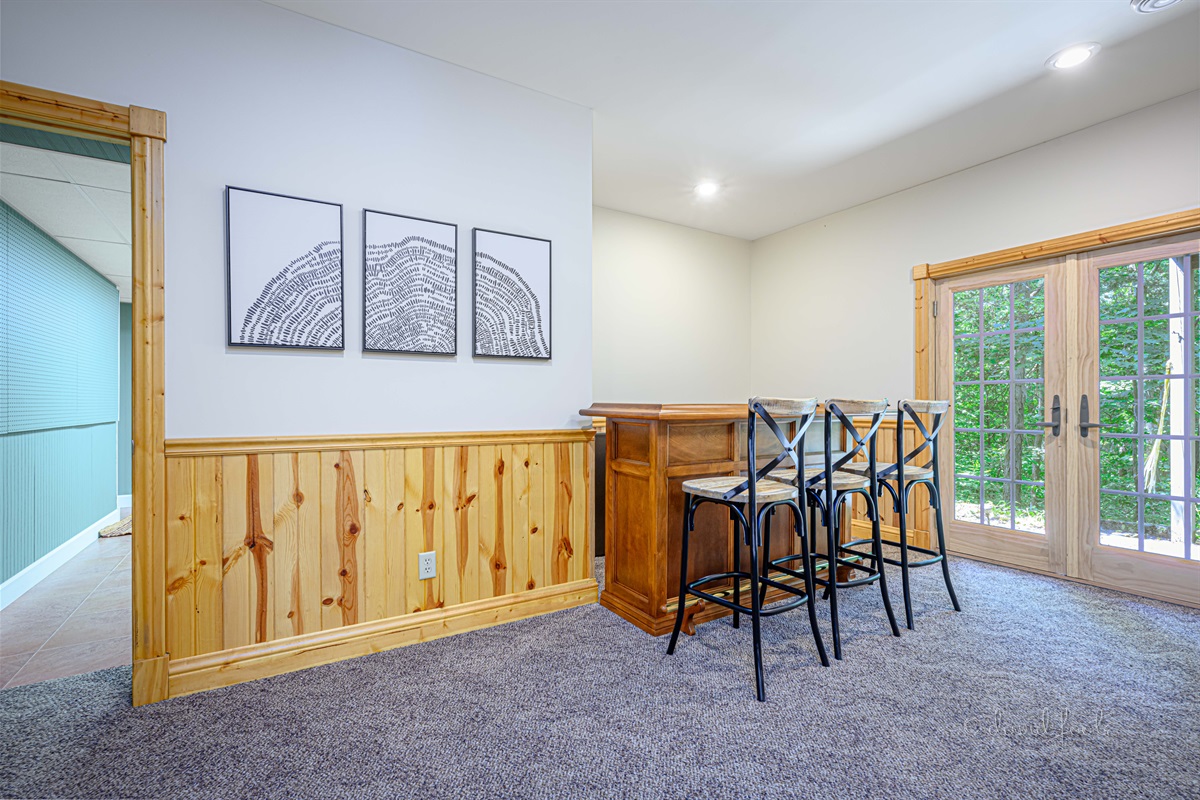 Dry bar with seating for 3 provides another space for gathering