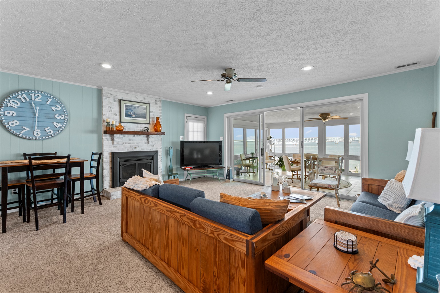Living Room: Bright and airy space with stunning water views, perfect for relaxation and fun!