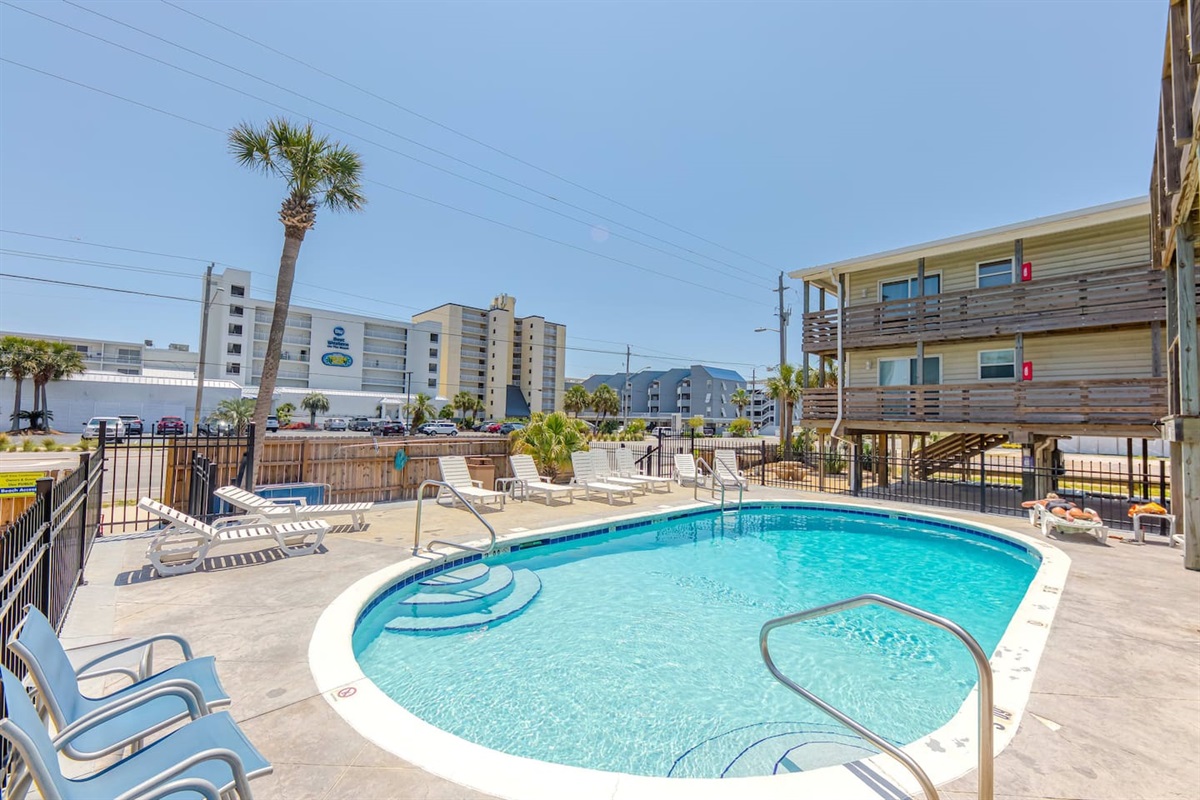 Poolside Paradise: Dive into fun at our refreshing pool, surrounded by swaying palms and sunshine!