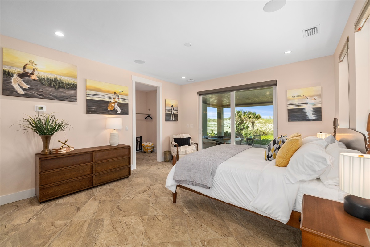 Spacious guest bedroom with king bed and bright natural light