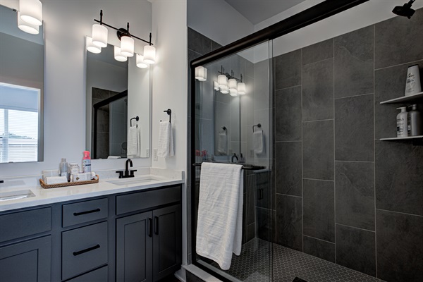 Relax in the serene master bedroom - a comfortable king-size bed, soft linens, and cozy pillows. Includes nightstands, lamps, and walk-in closet. 