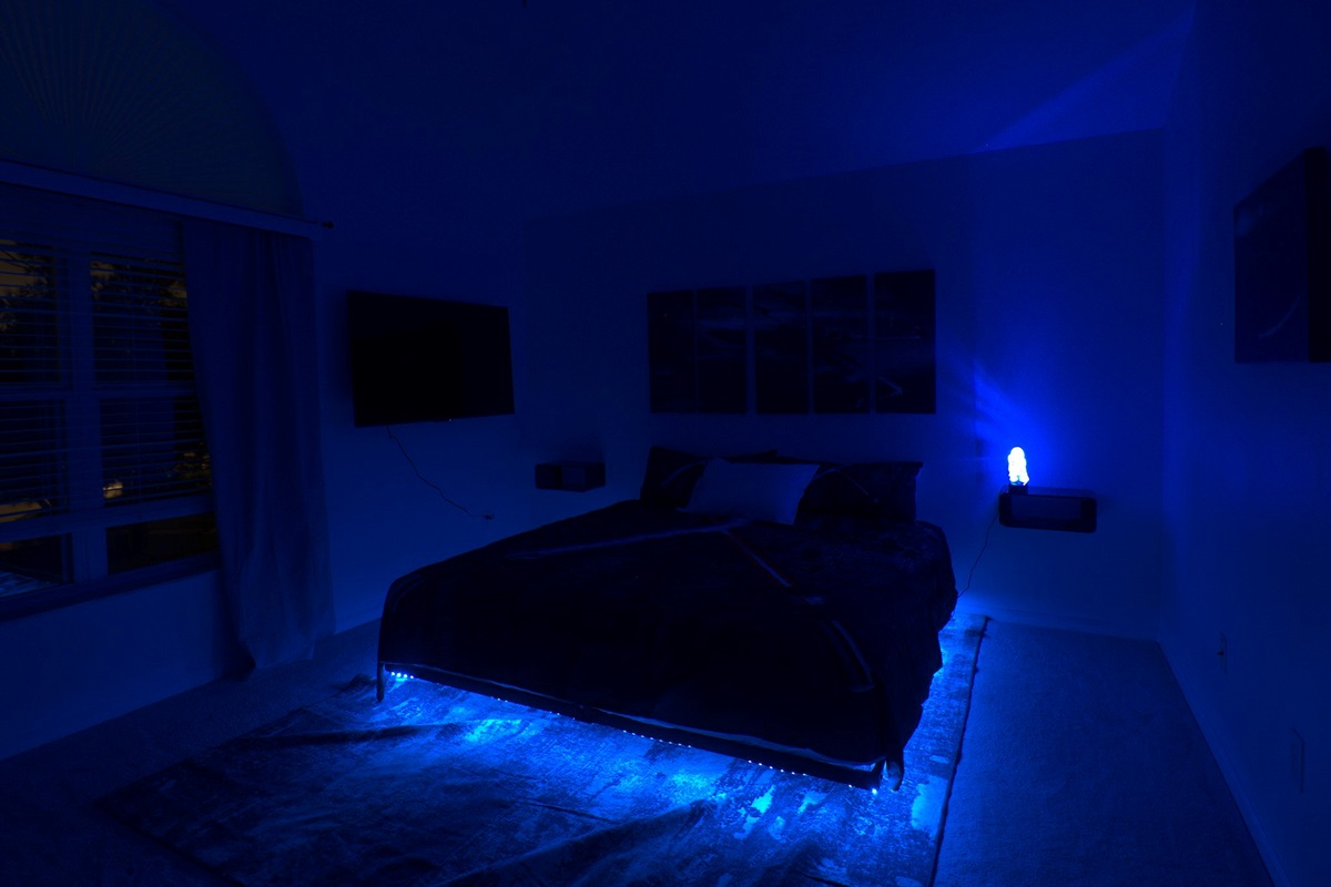 Star Wars room with king bed, LED lights, and R2D2 projection. 