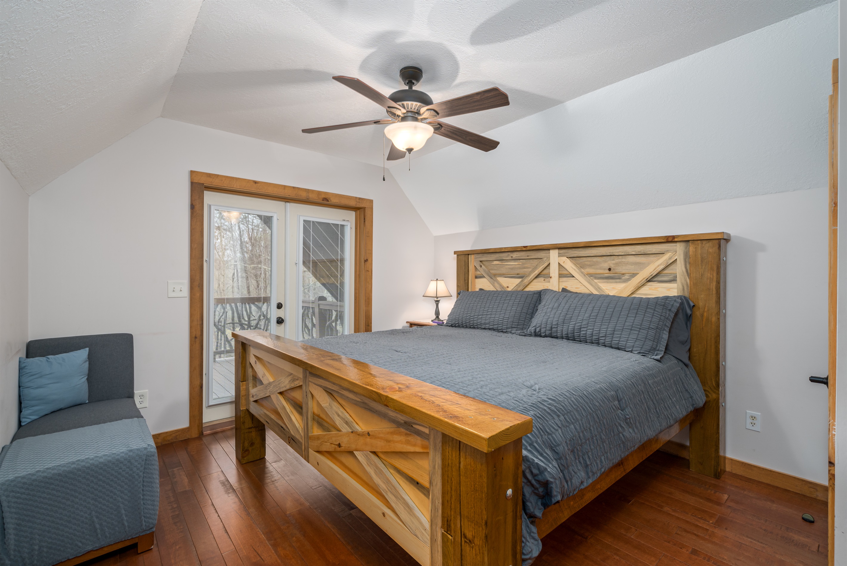 Upper level bedroom with private balcony.