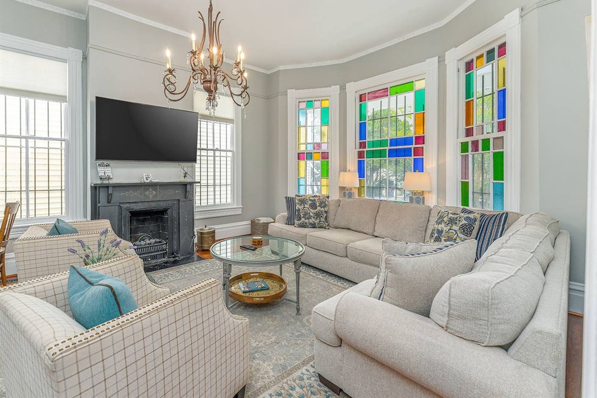 Stain glass windows facing south let in brilliant light throughout the day!  Spacious with double pocket doors leading into the dining room - great for entertaining.  Close the pocket doors, pull out the sofa bed make this living room a 4th bedroom!