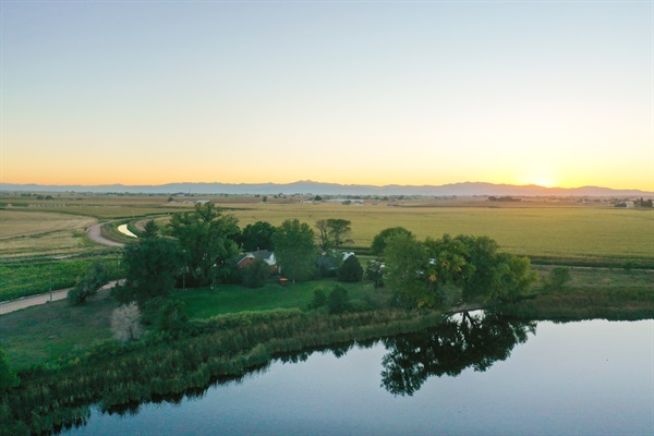 The calm lake mirrors the pastel skyline for an idyllic retreat setting.