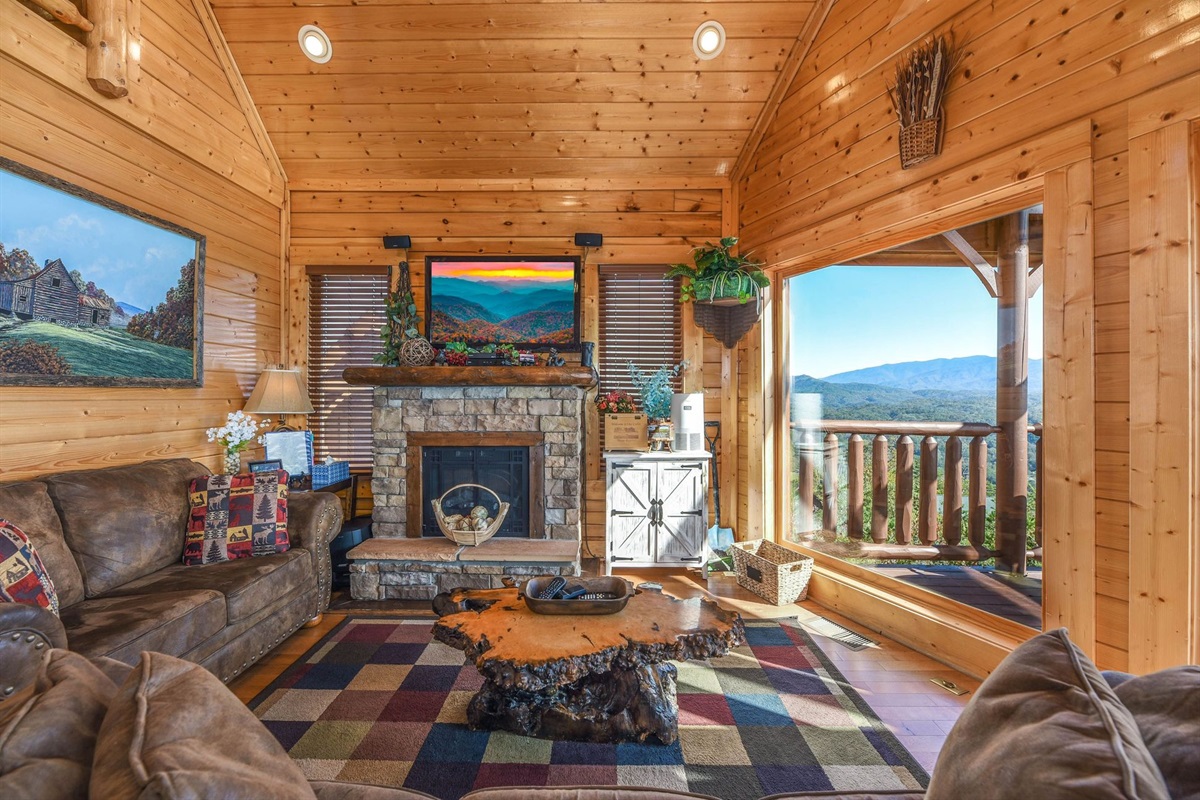 - Gather around the stone fireplace surrounded by warm wood interiors and mountain charm   - Sink into the cozy seating and admire scenic Smoky Mountain views from every angle   - Rustic cabin comfort meets breathtaking nature through large picture windows
