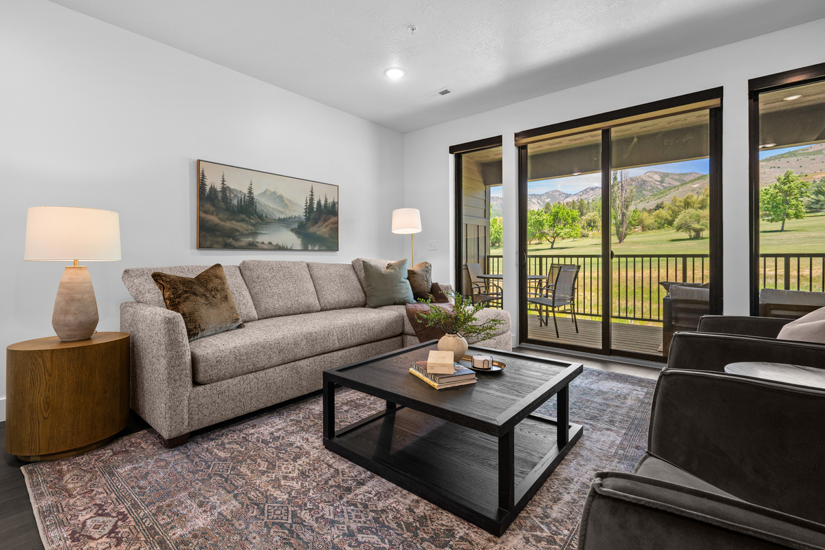 Relax in the comfortable living room with fairway and mountain views.